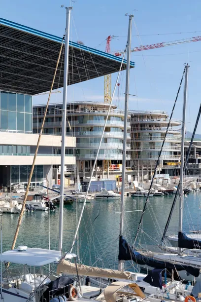 Boats are docked in front of a building under construction