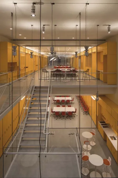 a large room with tables and chairs and stairs