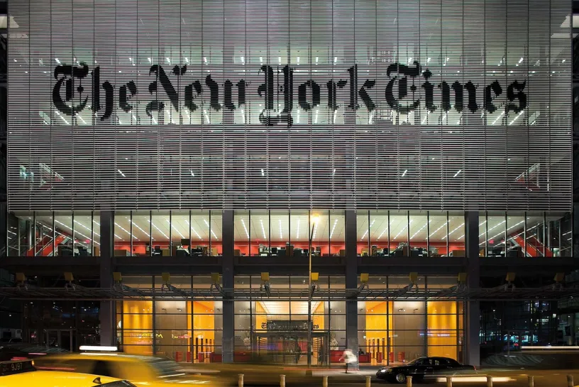 A large building with a lot of windows and the new york times written on it