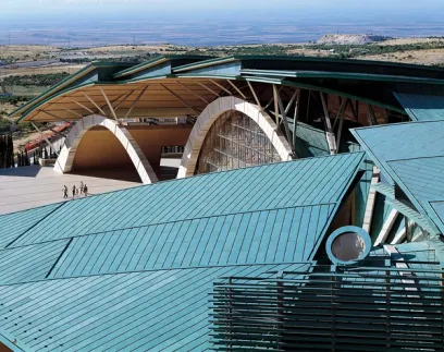 An aerial view of a large building with a green roof