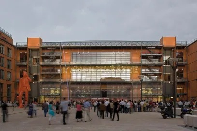 A group of people are standing in front of a large building