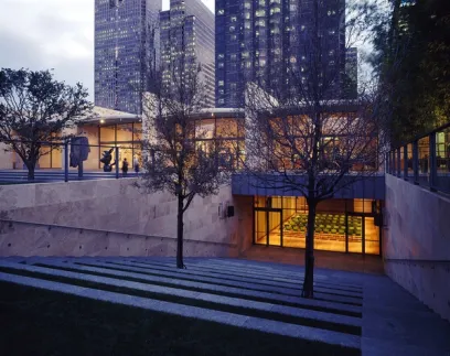 A building with stairs leading up to it and trees in front of it