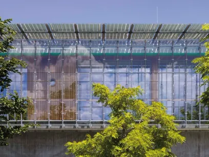A building with a lot of windows and solar panels on the roof