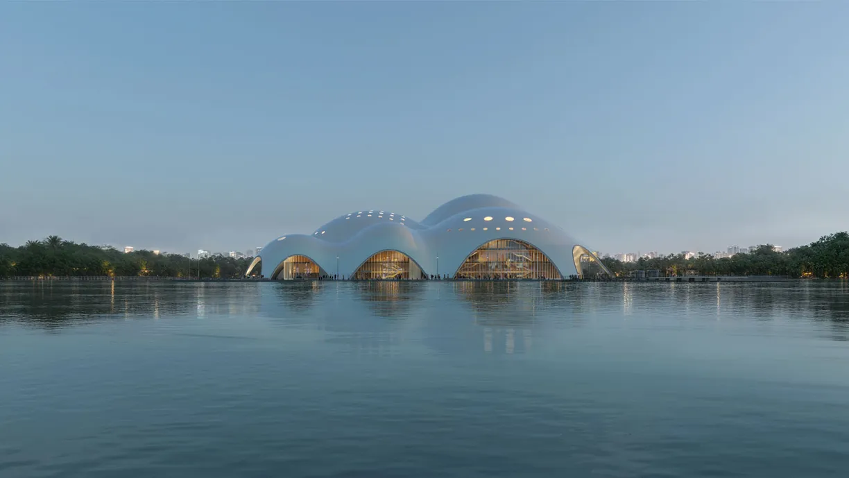 a large building is sitting on top of a body of water .