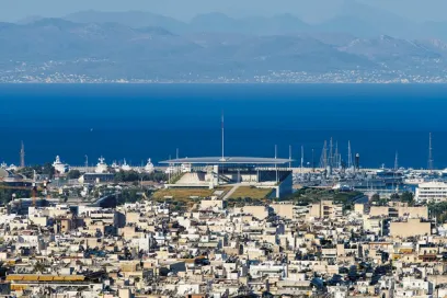 An aerial view of a city with the sea in the background
