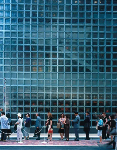 A group of people standing in front of a building