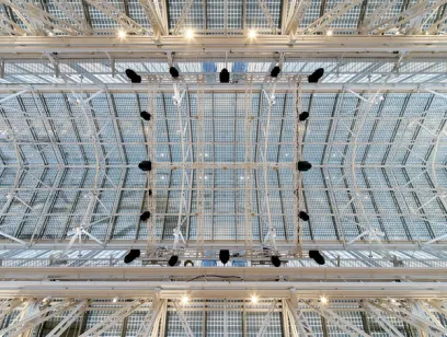 Looking up at the ceiling of a building with a lot of lights hanging from it