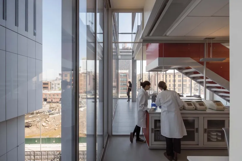 two women are working in a lab with a lot of windows .