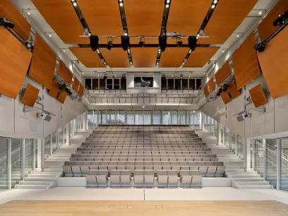 A large auditorium with rows of seats and stairs leading up to it
