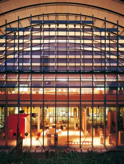 A large building with a lot of windows and a sign that says no parking