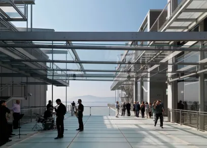 A group of people are standing under a glass roof