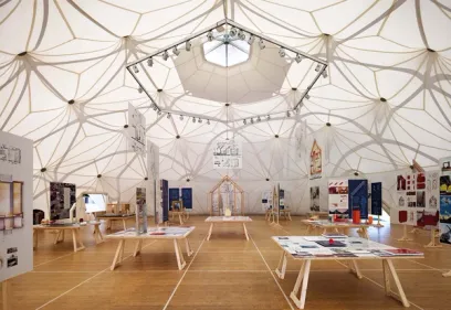 a large room with tables and a dome in the middle of it .
