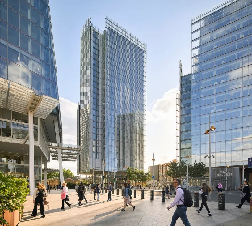 a large building with a lot of windows and a wooden bench in front of it .