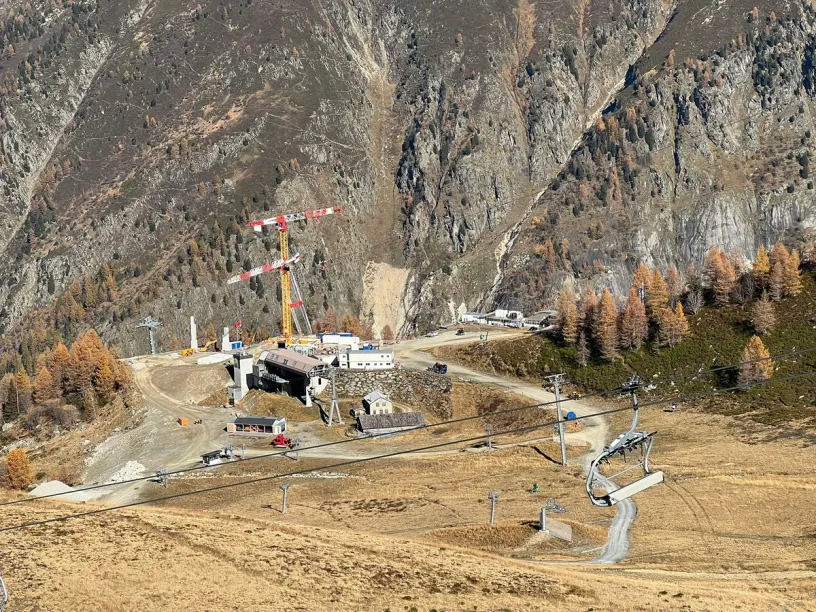 a ski lift is being built in the mountains .