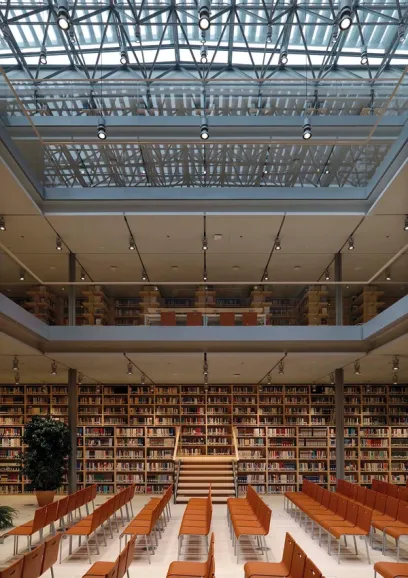 a large library with lots of books and chairs