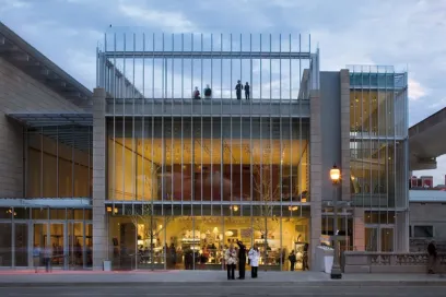 A large building with a lot of windows and people standing outside of it