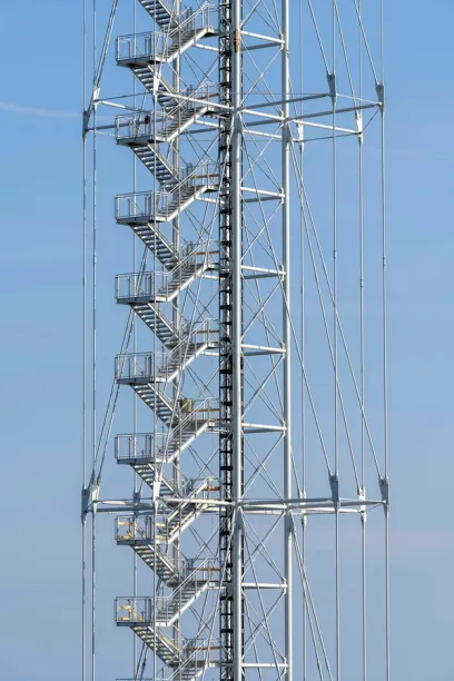 A very tall metal structure with stairs going up to the top