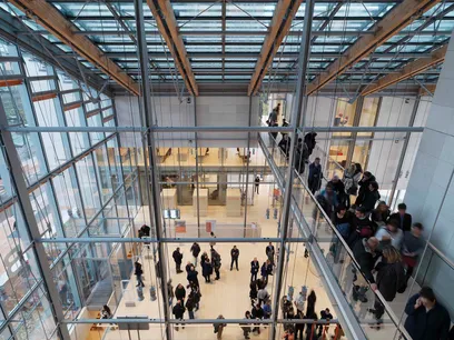 a large library with lots of books and chairs