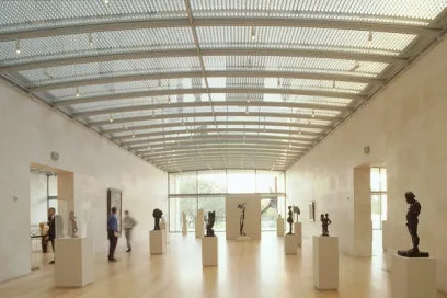 A group of people are looking at sculptures in a museum