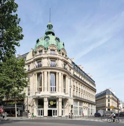 a large building with a green dome on top of it .