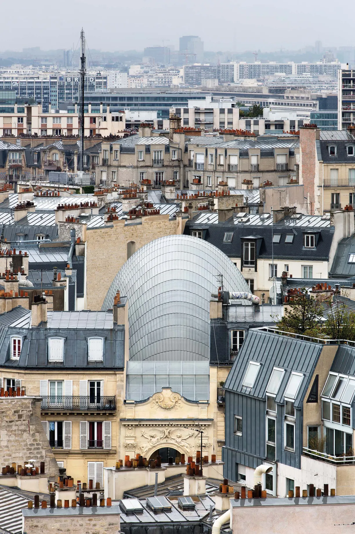 An aerial view of a city with a large dome in the middle