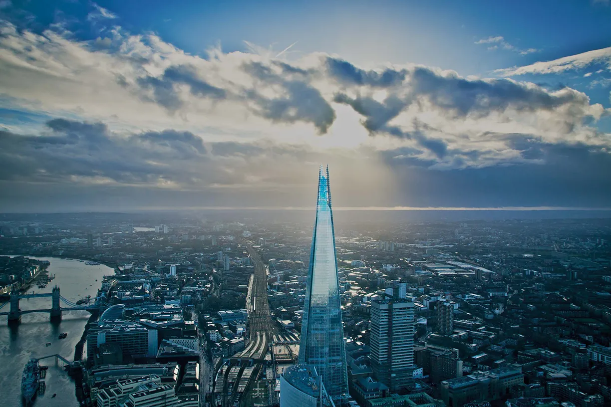 An aerial view of the shard in london with the sun shining through the clouds