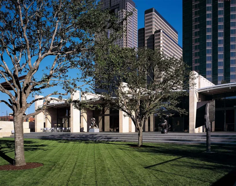 A large building with a lush green lawn in front of it