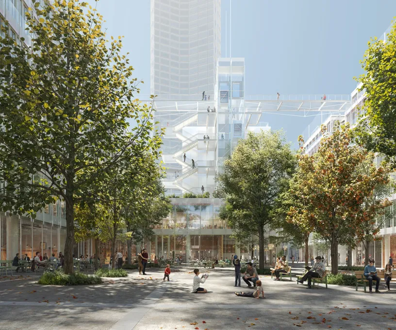 An urban plaza with trees and people, surrounded by modern buildings featuring transparent skywalks and outdoor staircases.