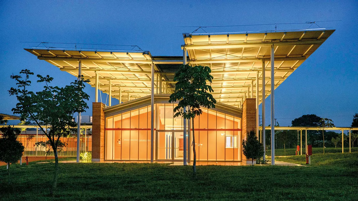 A large building with a lot of windows is lit up at night