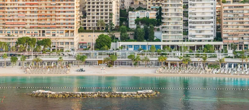 An aerial view of a beach with a lot of buildings in the background