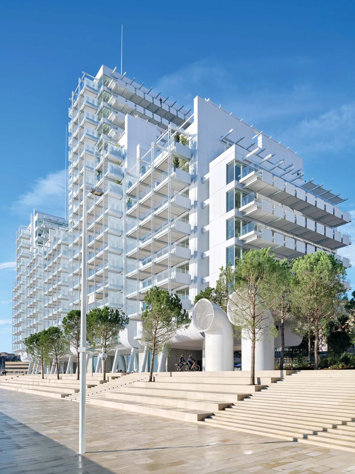A large white building with stairs leading up to it