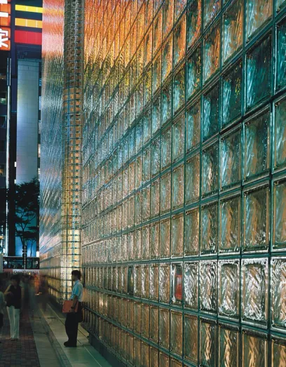 A man standing in front of a building with a sign that says am