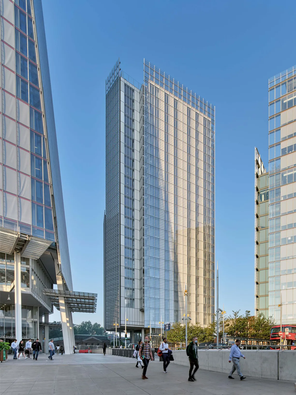 a group of people walking in front of a tall building