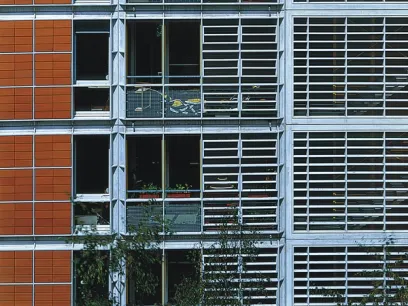 a building with a lot of windows and shutters on it .