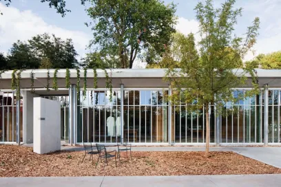 A building with a lot of windows and trees in front of it