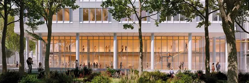 A large building with a lot of windows and trees in front of it