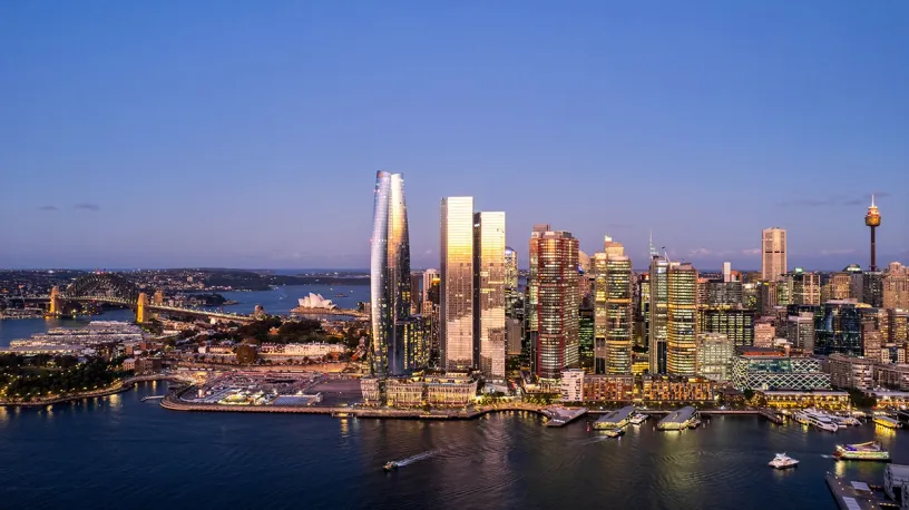 An aerial view of a city skyline with a body of water in the foreground
