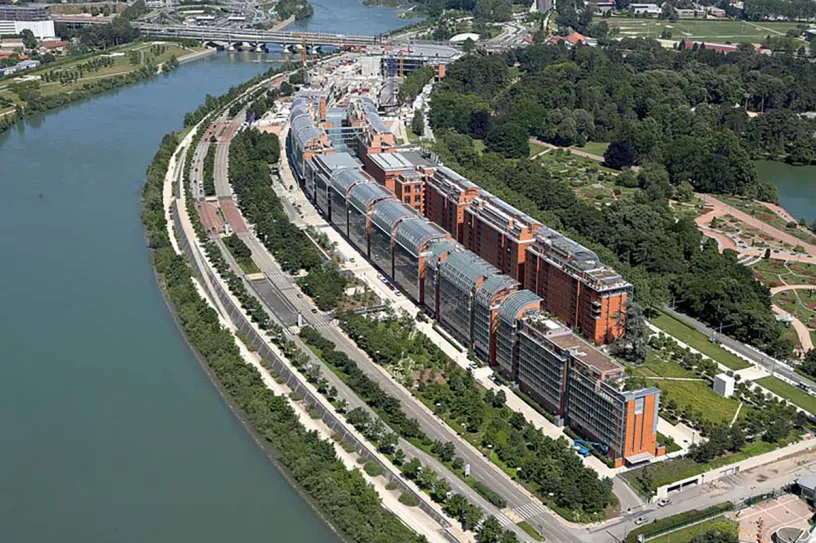 An aerial view of a large building next to a river