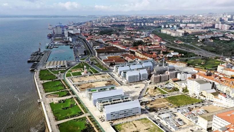An aerial view of a city with a large body of water in the background