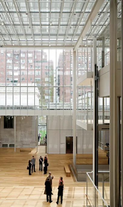 A group of people standing in a large building with a glass ceiling
