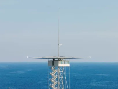 A very tall tower in the middle of the ocean