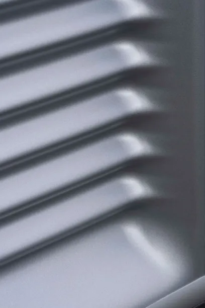 A close up of a metal surface with lines on it