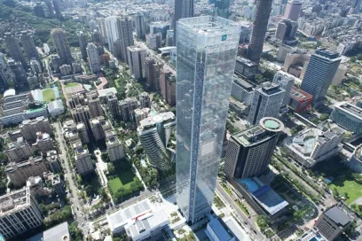 An aerial view of a city with a very tall building in the middle of it