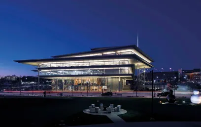 A large building with a lot of windows is lit up at night