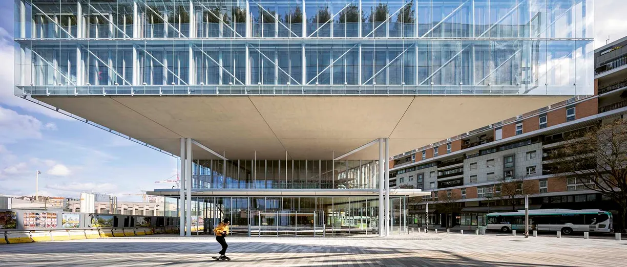 a man is riding a skateboard in front of a large building .
