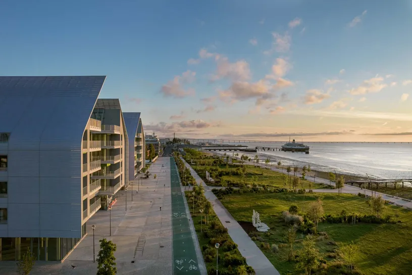 An aerial view of a row of buildings next to a body of water
