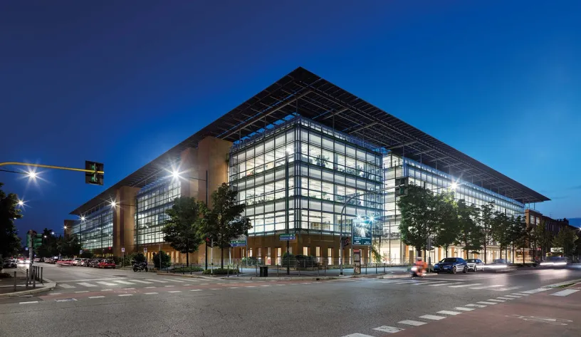 A large building with a lot of windows is lit up at night
