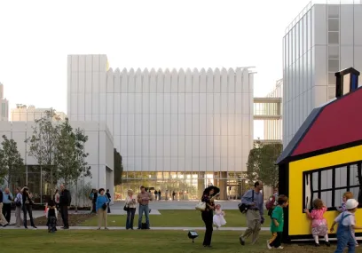 A group of people are standing in front of a large building