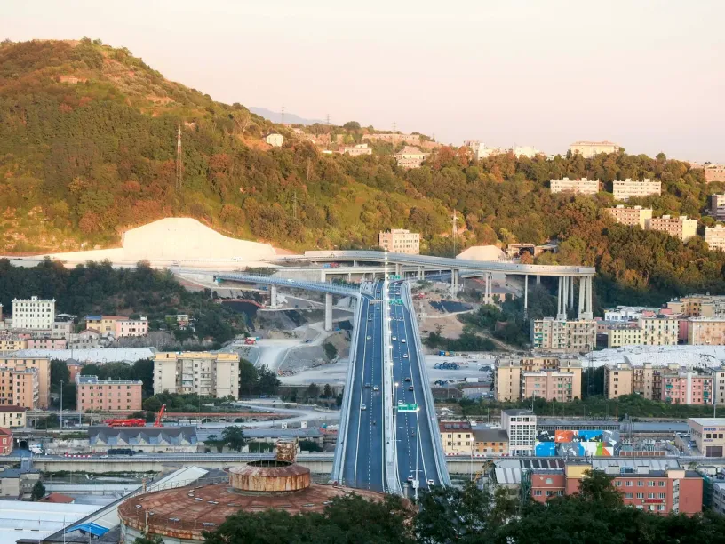 an aerial view of a highway going through a city .