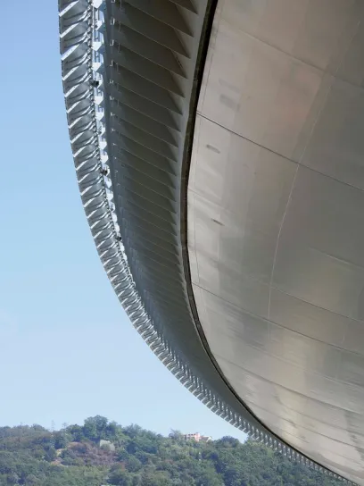 The roof of a building with a mountain in the background